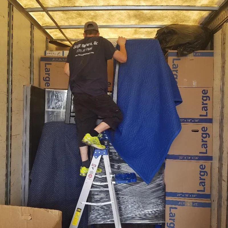 Swift Movers crew loading boxes into the moving truck